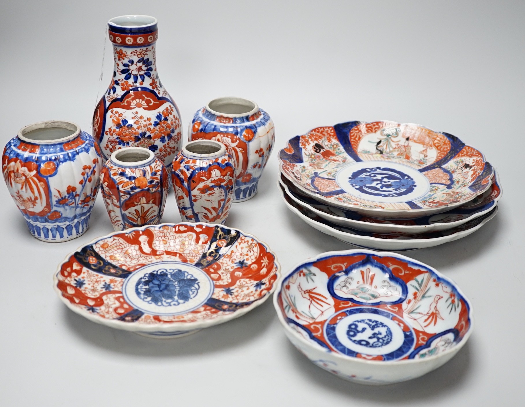 A group of Imari vases and dishes, tallest 19cm